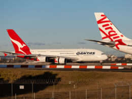 Qantas Airbus A320 taxiing behind Virgin Australia aircraft